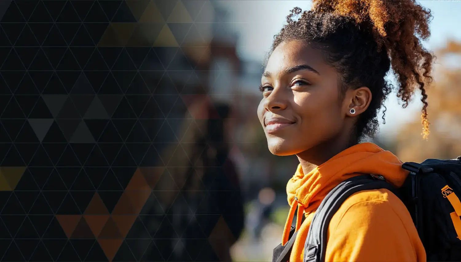 black female student in orange jacket with tree background